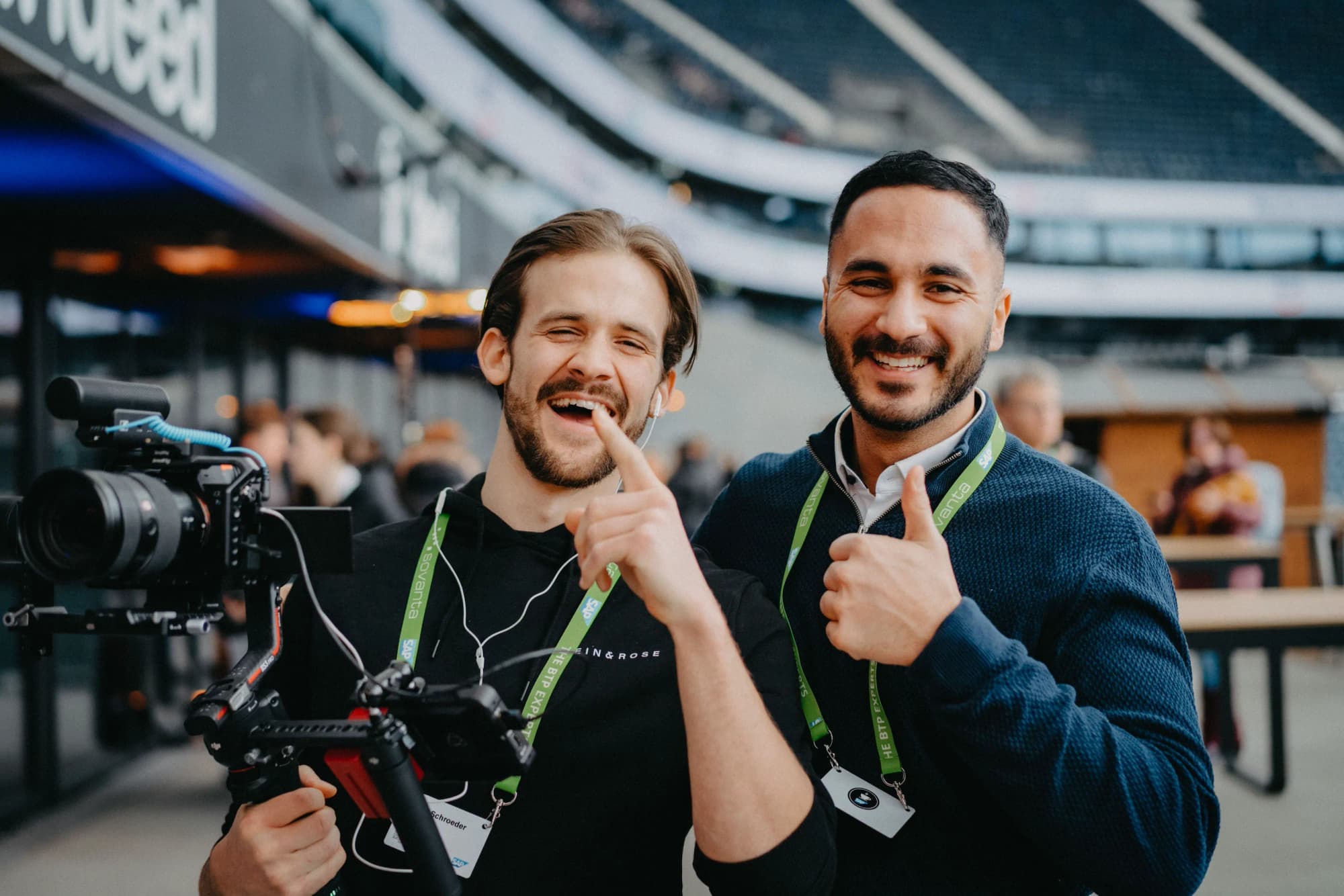 SAP behind the scenes: two men with a camera in an event hall