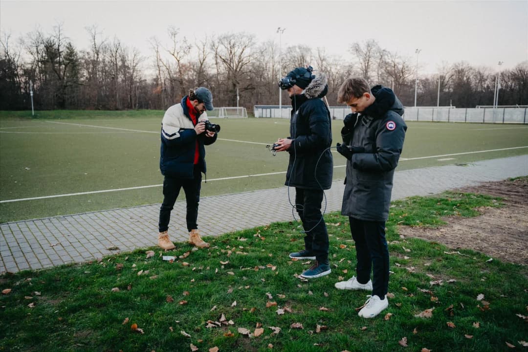 SAP behind the scenes: team with camera, VR headset and drone on a sports field