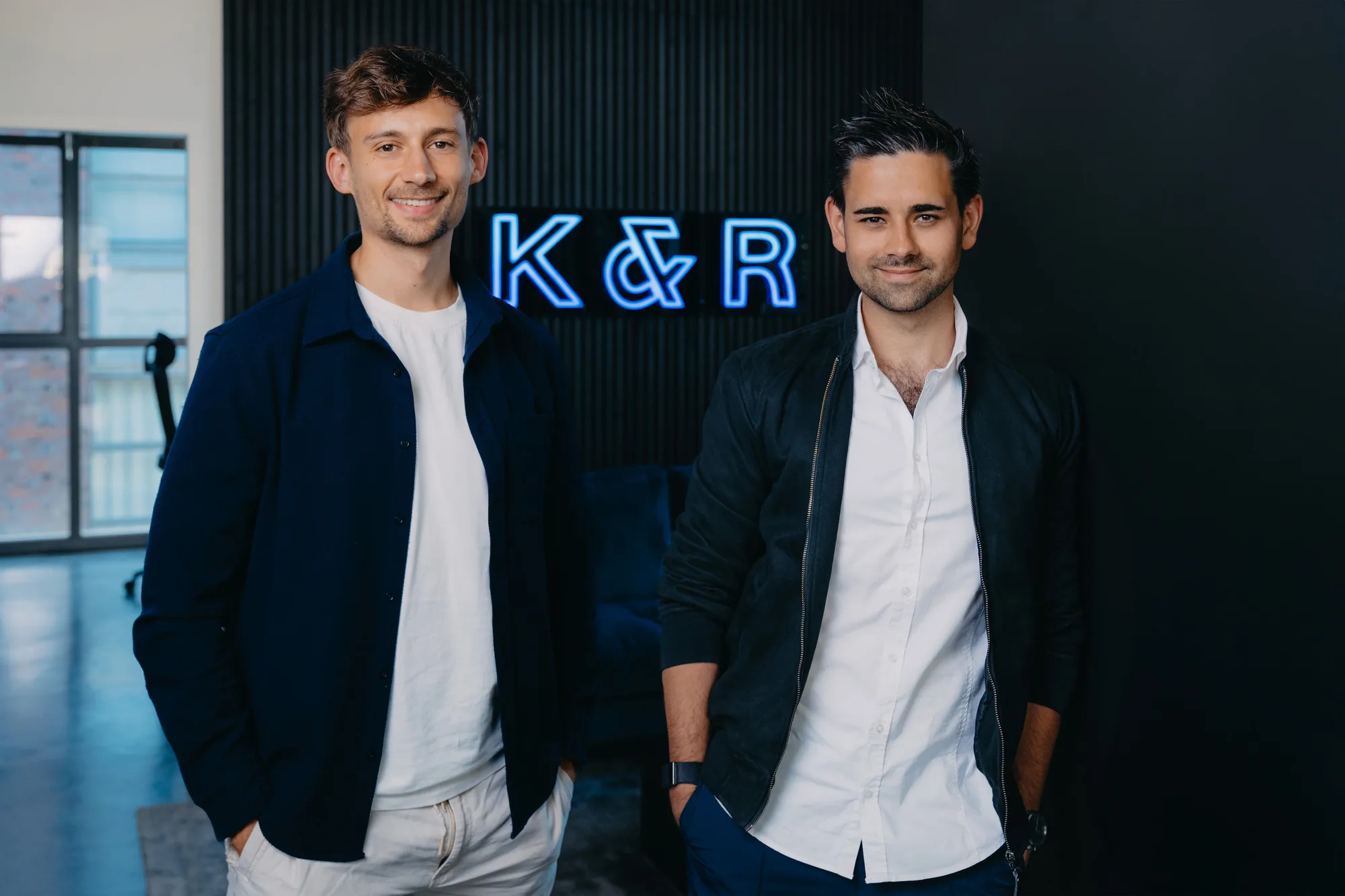 Founding duo Klein & Rose in front of the K&R neon logo