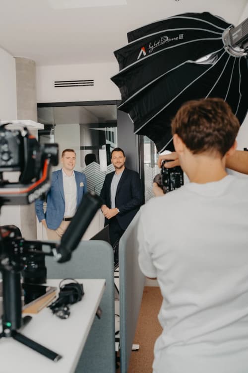 VAP behind the scenes: photographer taking a portrait photo in the office with a softbox