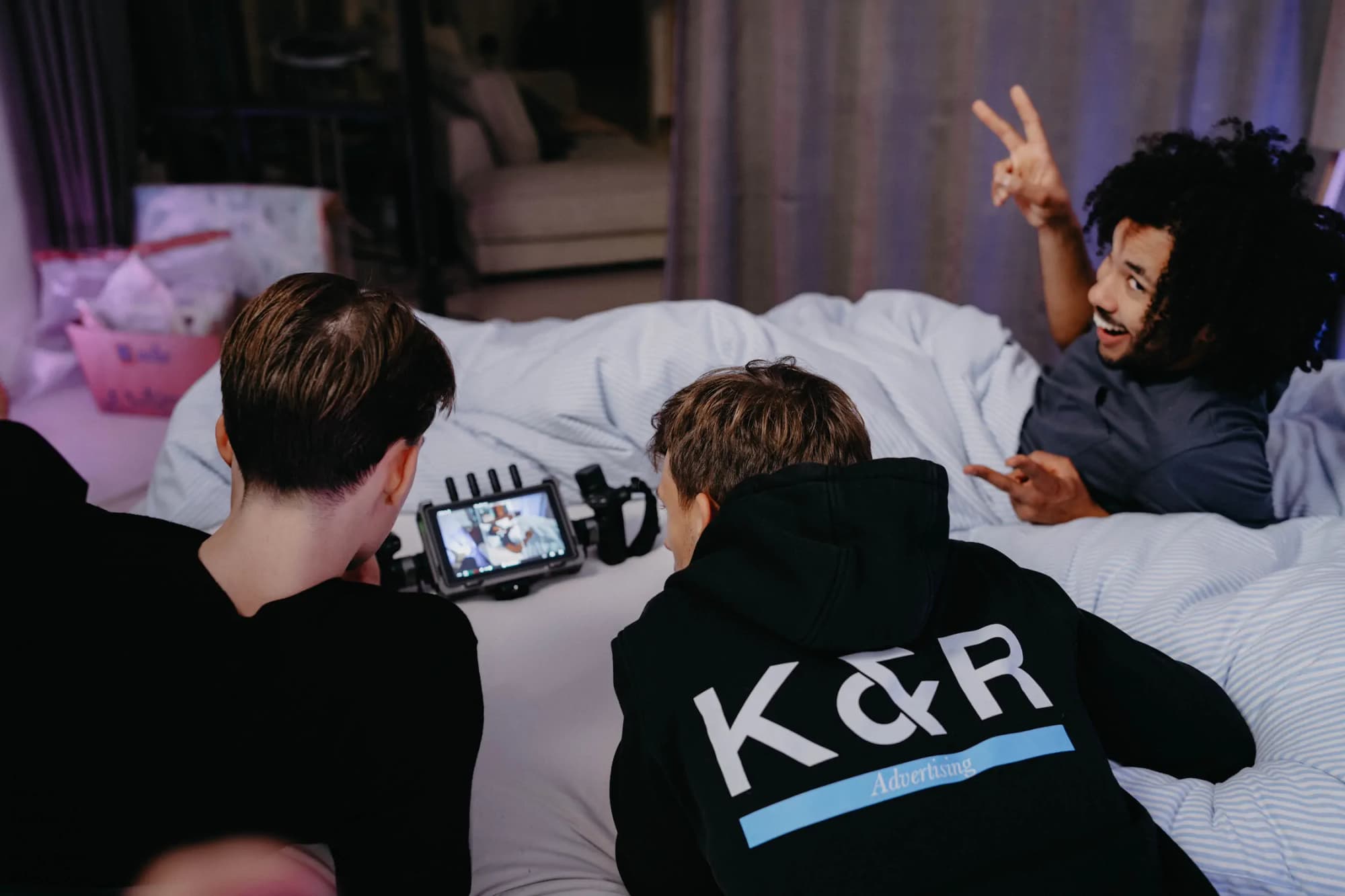 K&R behind the scenes: three men looking at a camera together